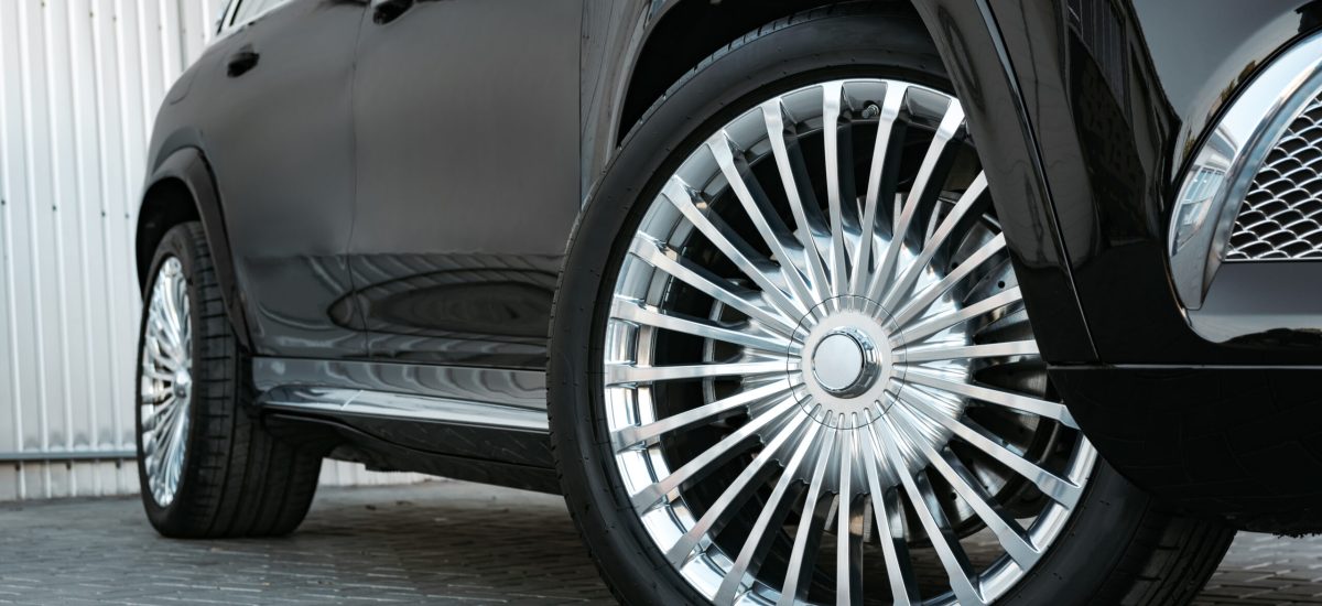 Aluminium rim of luxury black suv car wheel close up photo